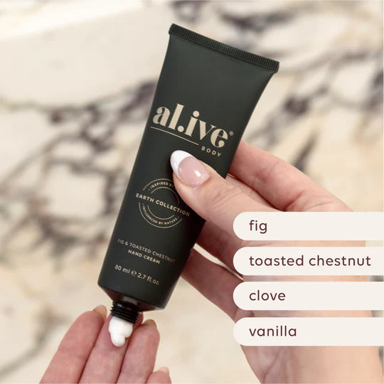 Hand holding a tube of 'al ive' hand cream with scents listed below.