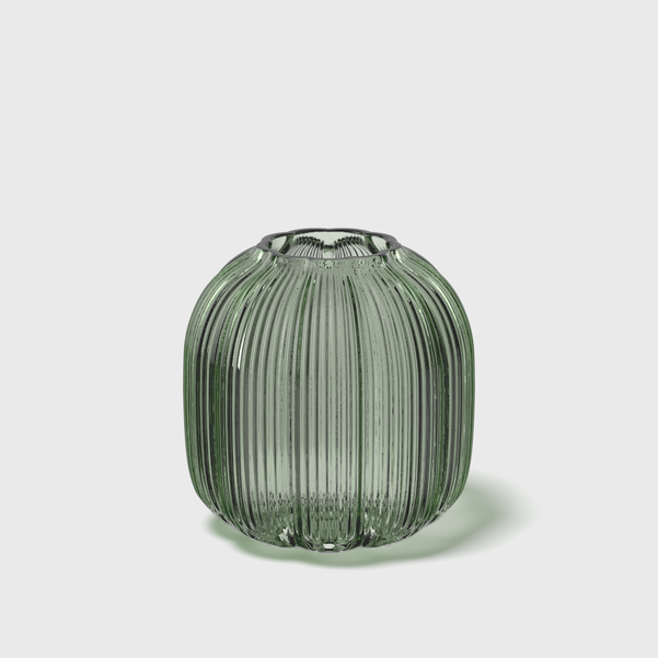 Green ribbed glass vase on a light gray background
