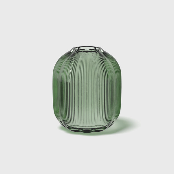 Green ribbed vase on a light gray background