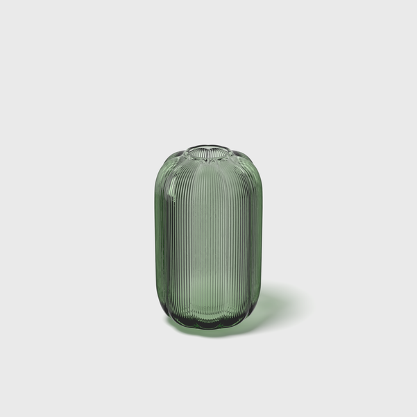 Green ribbed vase on a light gray background