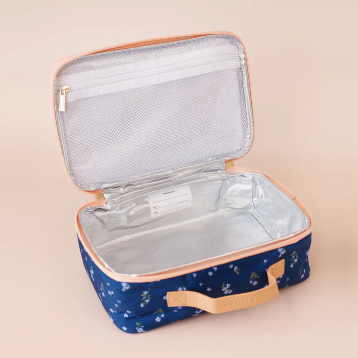 Open blue lunch bag with floral pattern on a beige background