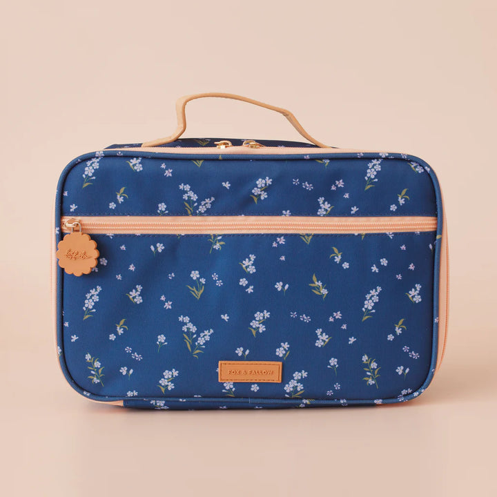 Blue floral-patterned lunch bag with gold accents on a beige background