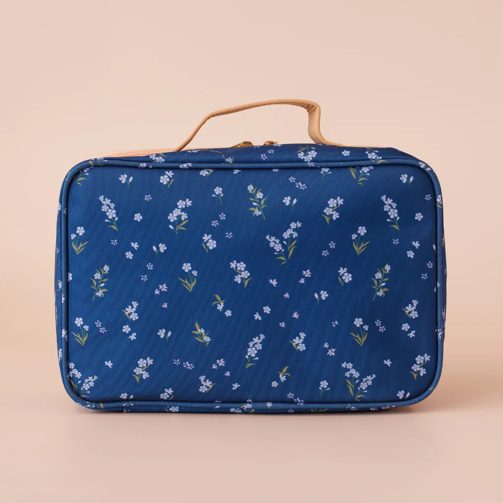 Blue floral-patterned lunch bag on a beige background