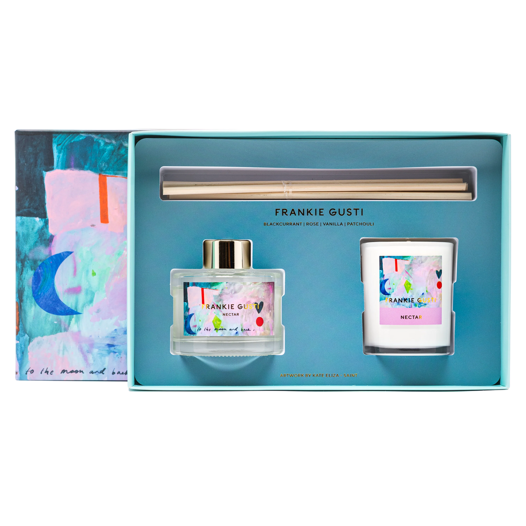 Frankie Gusti perfume and candle set in a blue box with colorful design