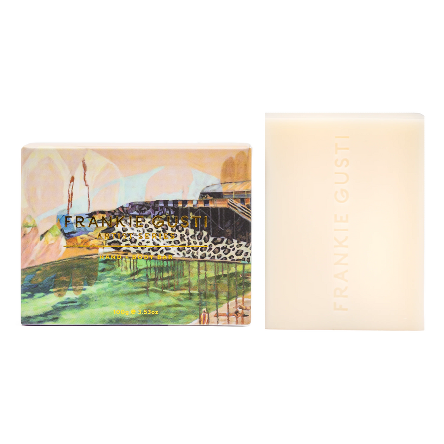 Bar of soap with a decorative packaging featuring a scenic design and brand name.