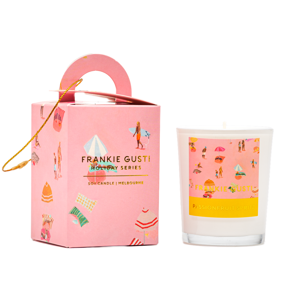 Pink Frankie Gusti candle with decorative packaging on a white background