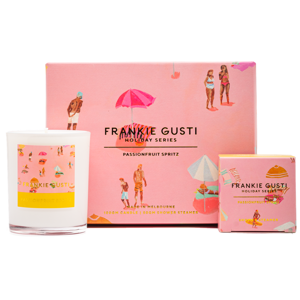 Frankie Gusti holiday series product with pink packaging and a candle.