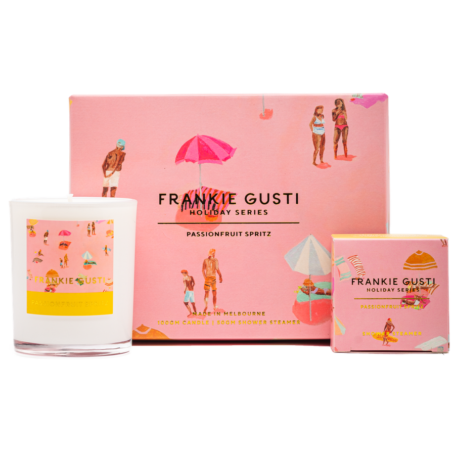 Frankie Gusti holiday series product with pink packaging and a candle.