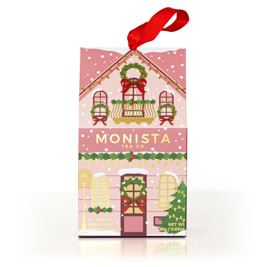 Christmas-themed tea packaging with a red ribbon on a white background