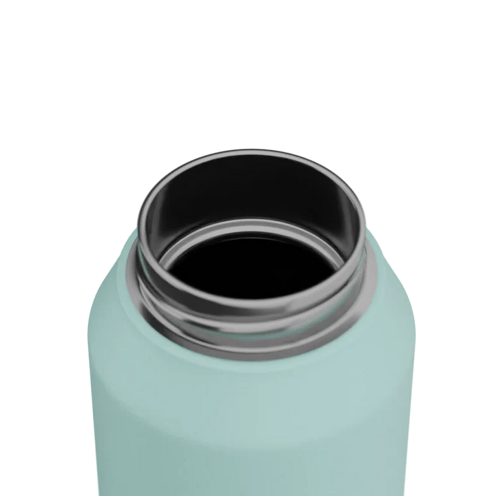 Close-up of a light blue water bottle with a black interior on a white background