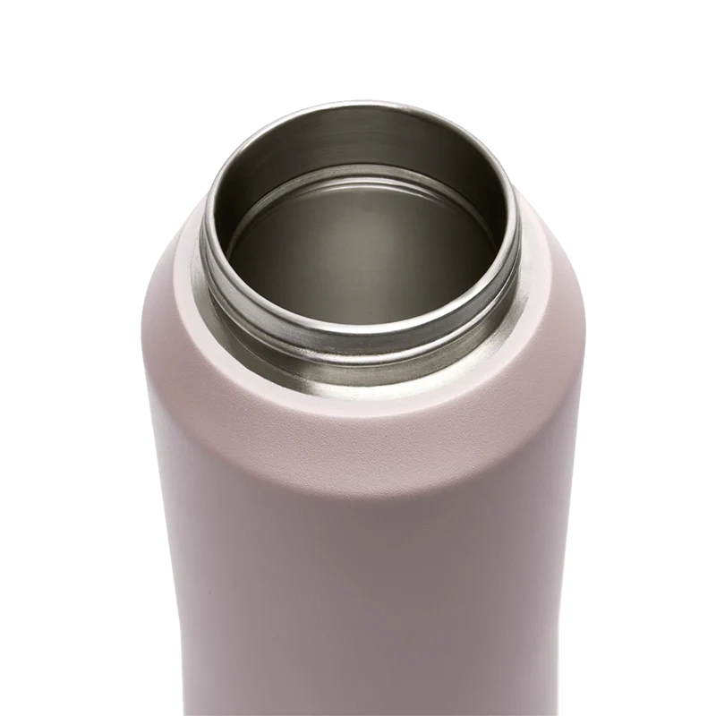 Close-up of a pink drink bottle with a silver interior on a white background
