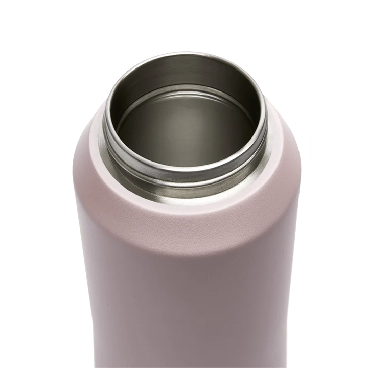 Close-up of a pink drink bottle with a silver interior on a white background