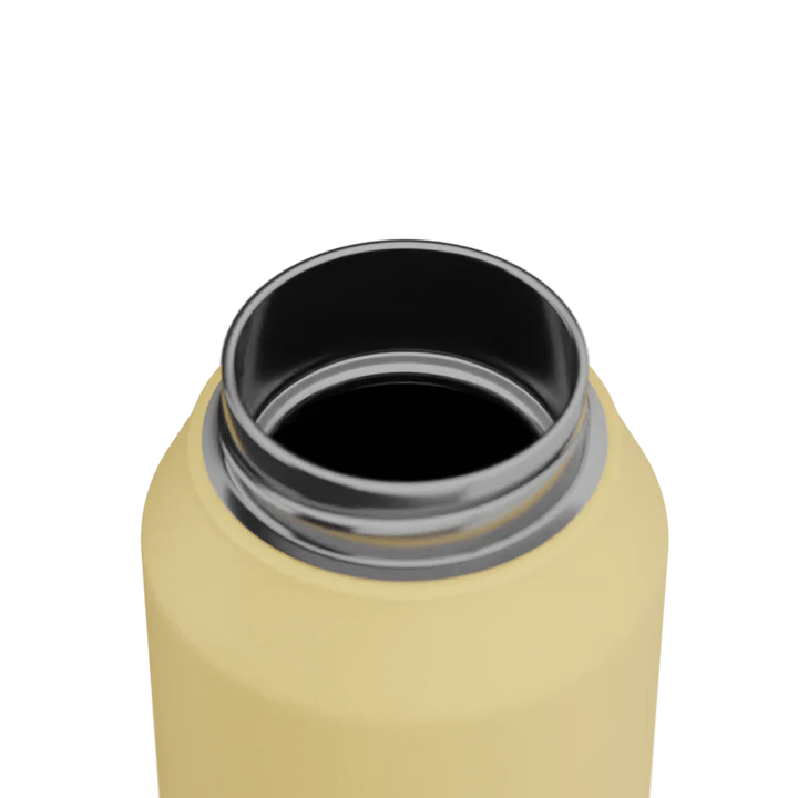 Close-up of a yellow water bottle with a silver interior on a white background