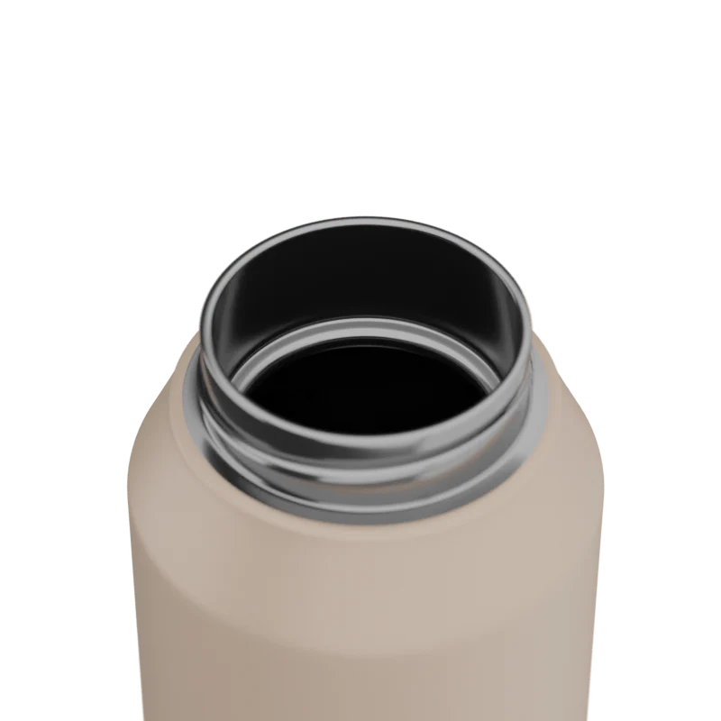Close-up of a beige water bottle with a black interior on a white background