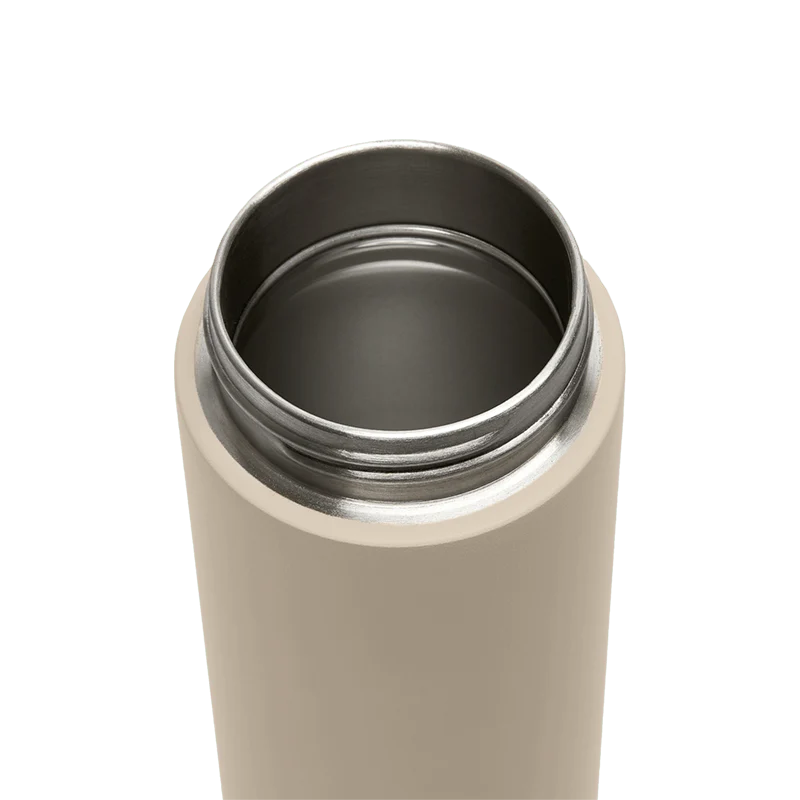 Beige thermos with black interior on a white background
