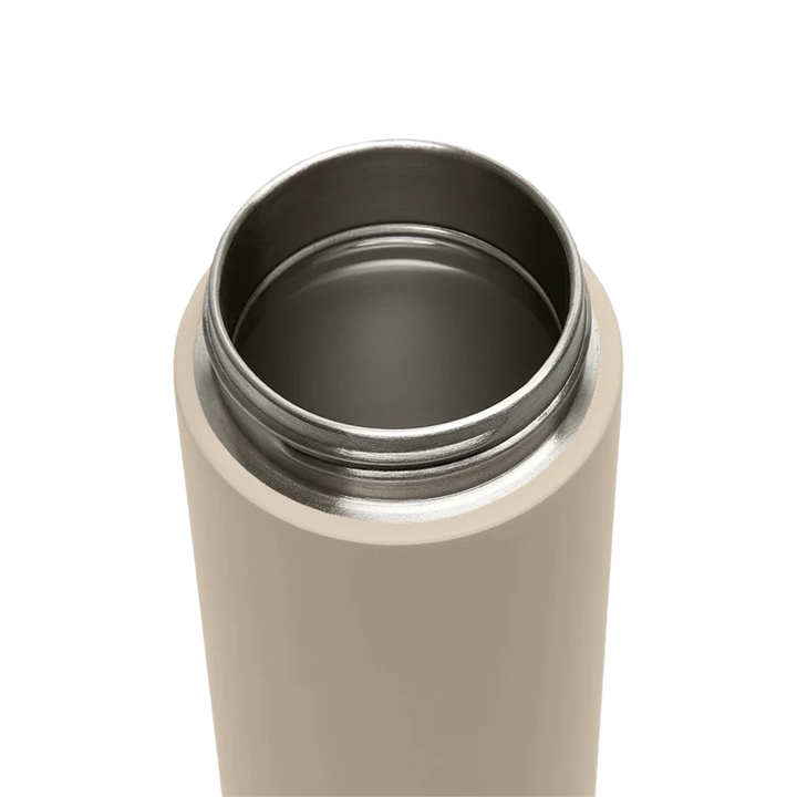Beige thermos with black interior on a white background