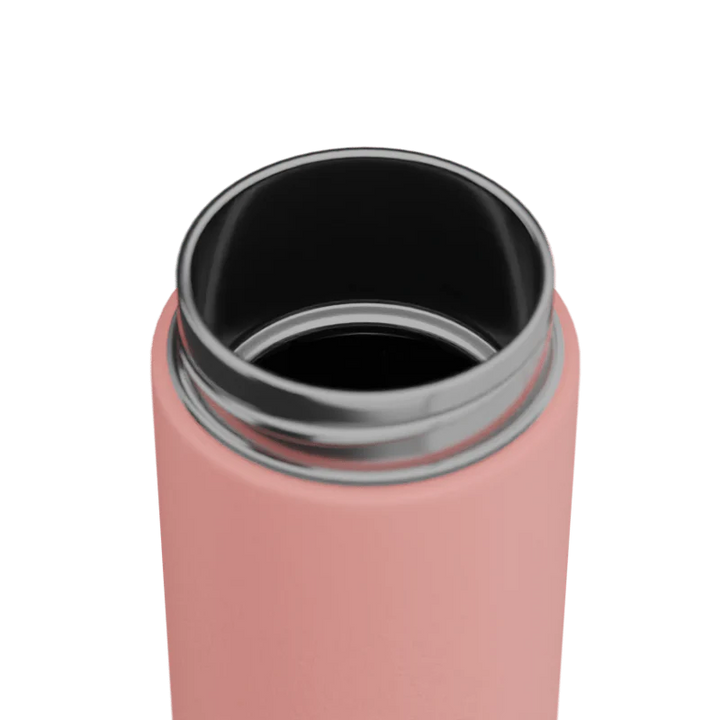 Close-up of a pink drink bottle with a silver rim on a white background
