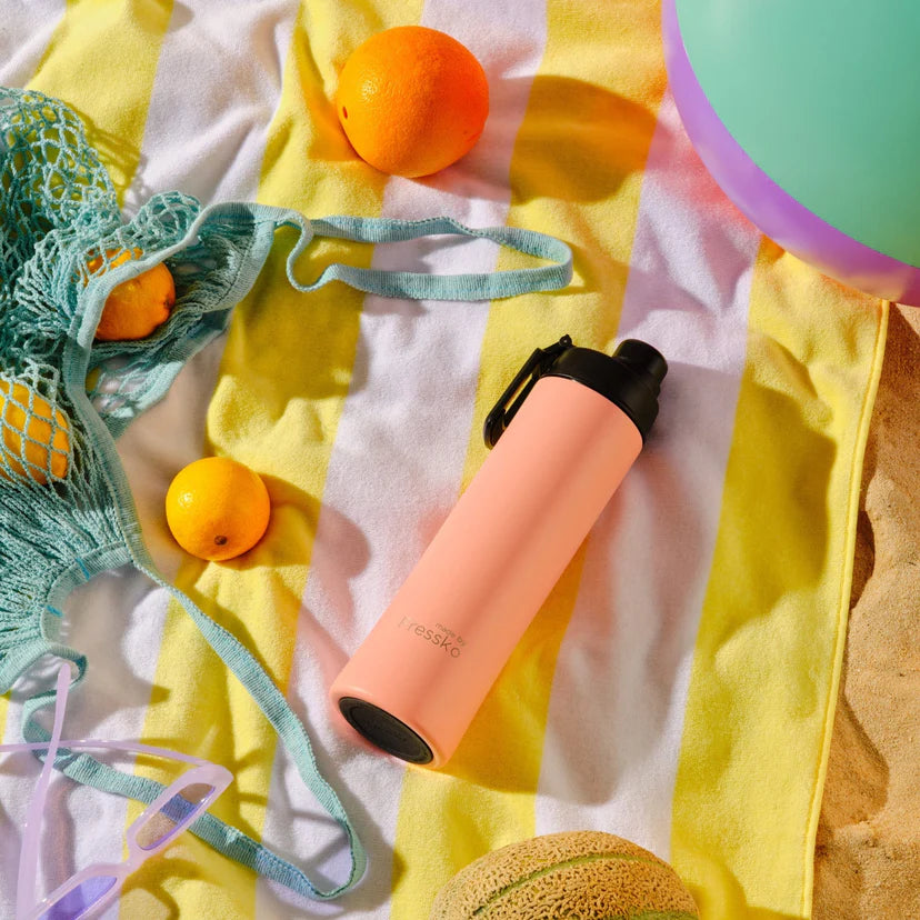 pink water bottle, and green bag on a yellow and white fabric background