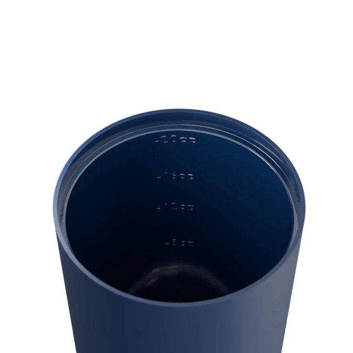 Navy blue tumbler with measurement markings on a white background