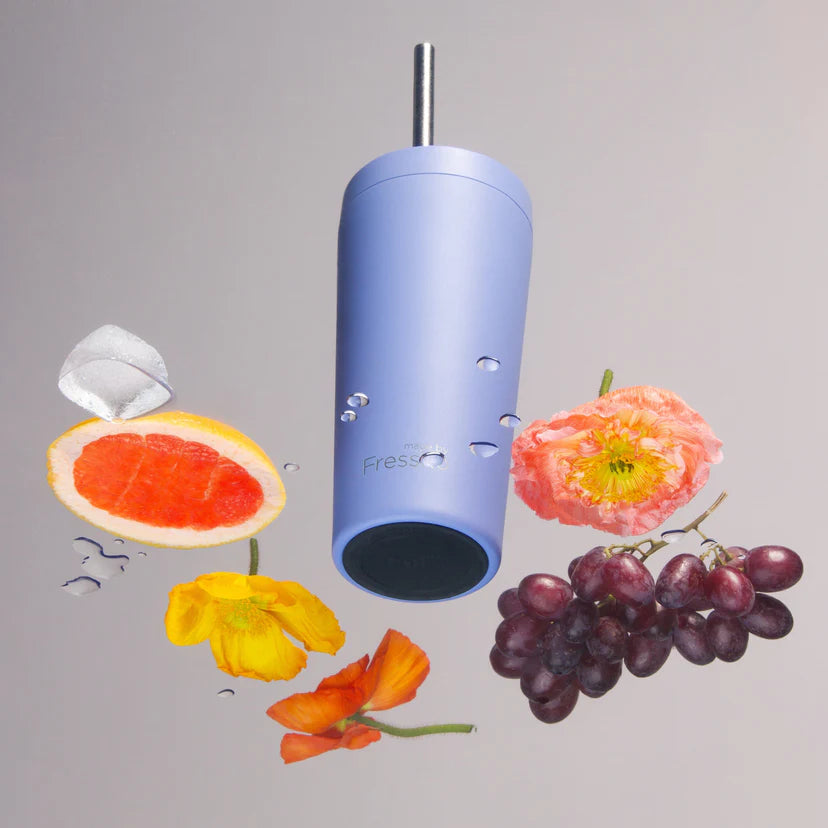 Blue cylindrical device with flowers and fruits on a gray background