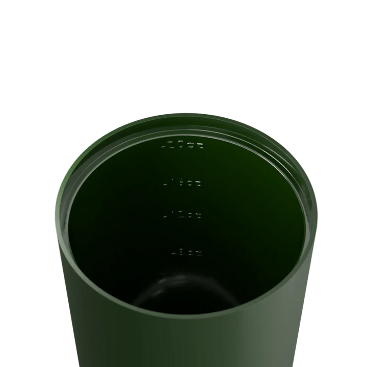 Green tumbler with a lid on a white background