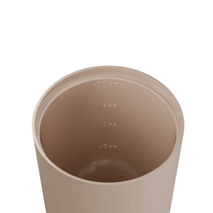 Beige measuring cup with volume markings on a white background