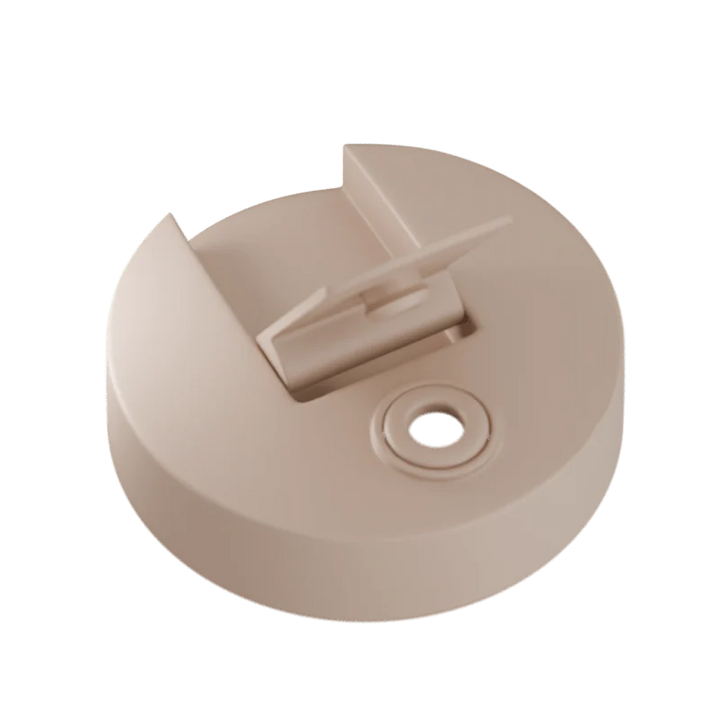 Beige plastic component on a white background