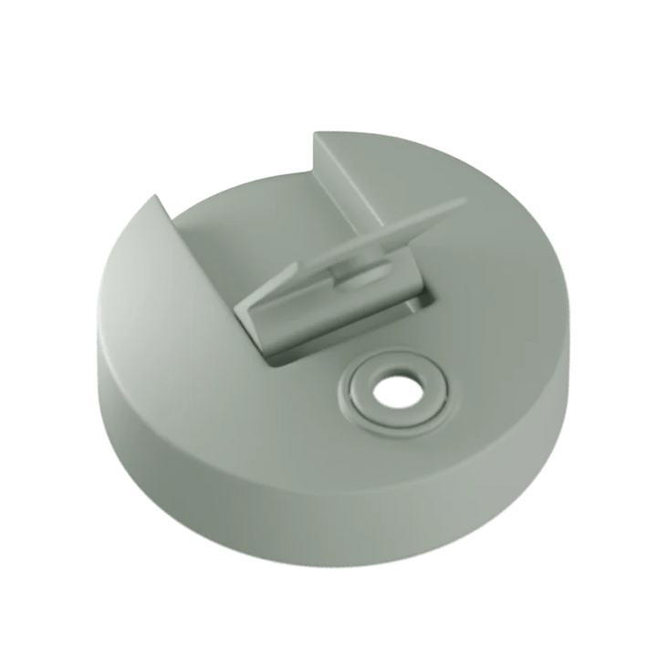 Sage green plastic component on a white background