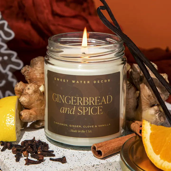 Candle labeled 'Gingerbread and Spice' with ginger, cinnamon, and vanilla on a rustic background.