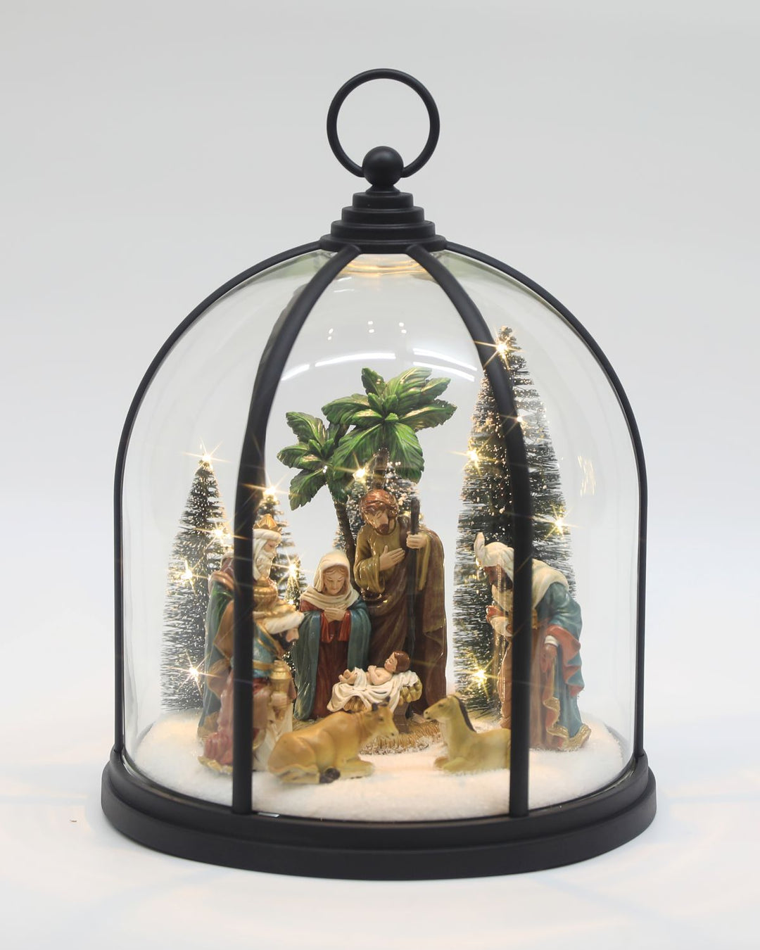 A glass dome with a nativity setting inside