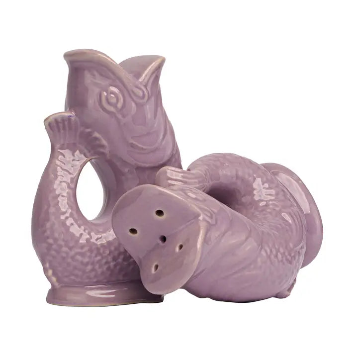 Purple ceramic salt and pepper shakers in the shape of fish on a white background
