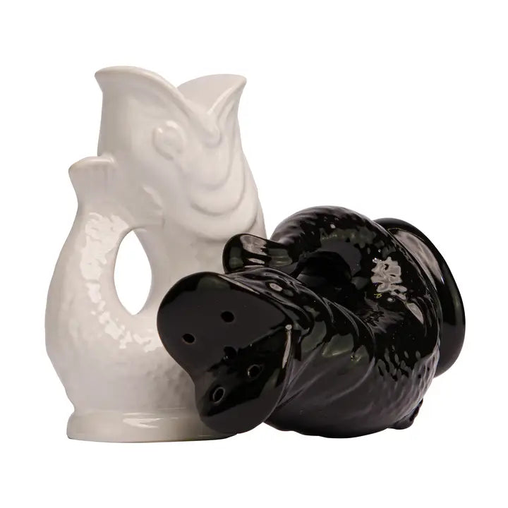 White and black ceramic salt and pepper shakers on a white background