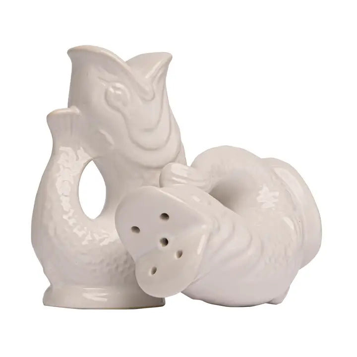 White ceramic salt and pepper shakers shaped like a fish on a white background
