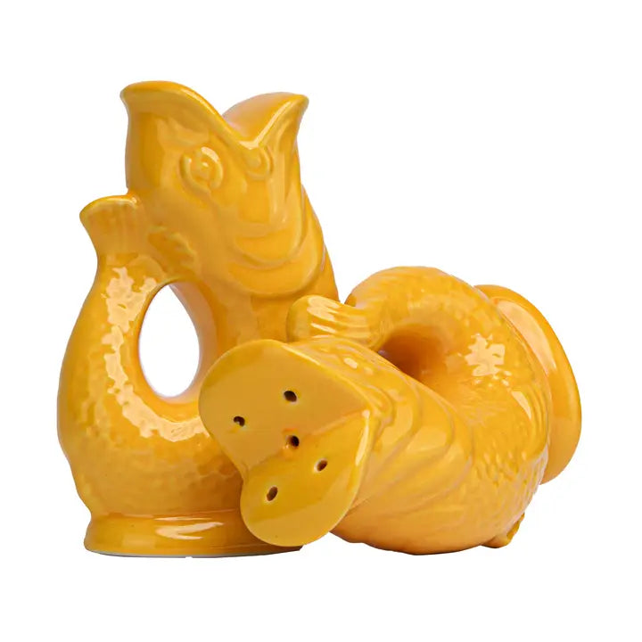 Yellow ceramic salt &amp; pepper shakers in the shape of fish on a white background