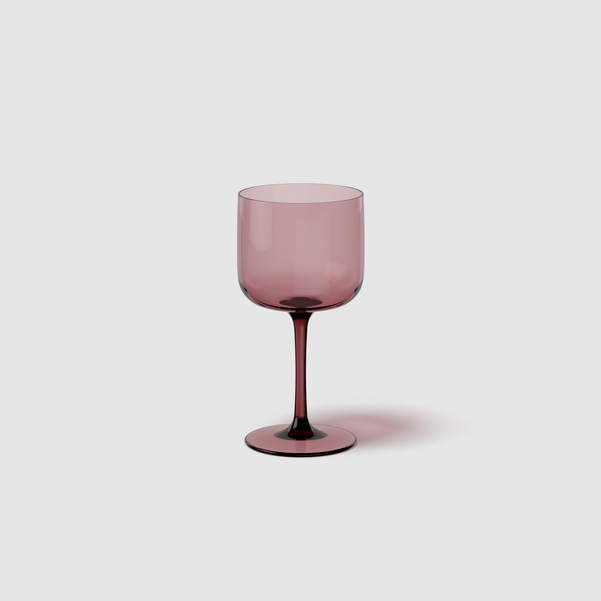 Pink wine glass on a light gray background