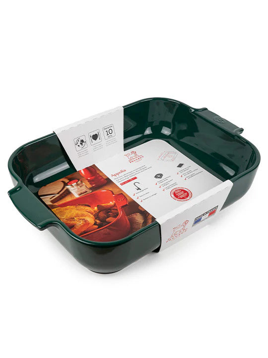 Green ceramic baking dish with packaging on a white background