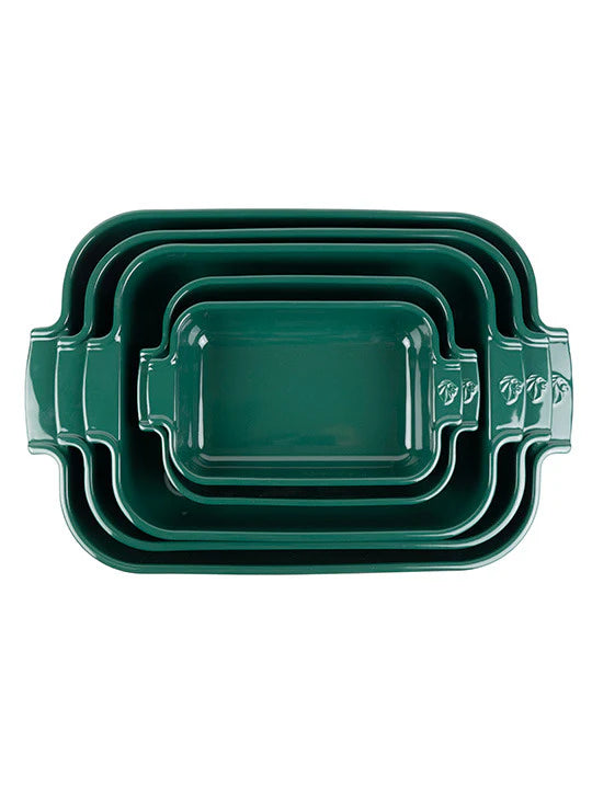 Set of three green rectangular ceramic baking dishes stacked on a white background