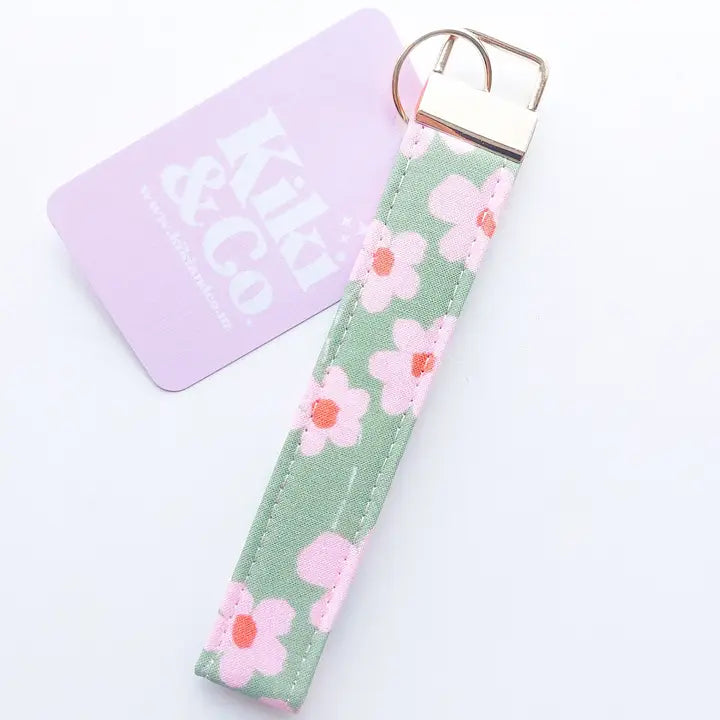 Floral keychain on a light green background