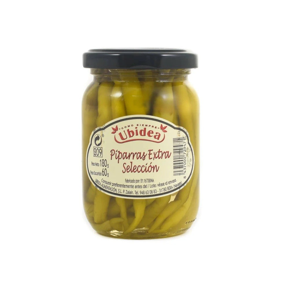 Jar of pickled green guindilla peppers with a Uvidea label on a white background
