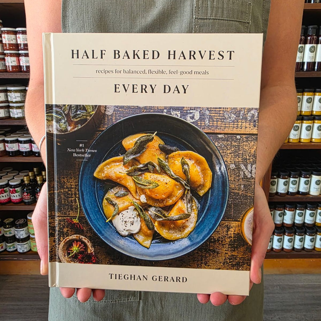 Person holding a cookbook titled &