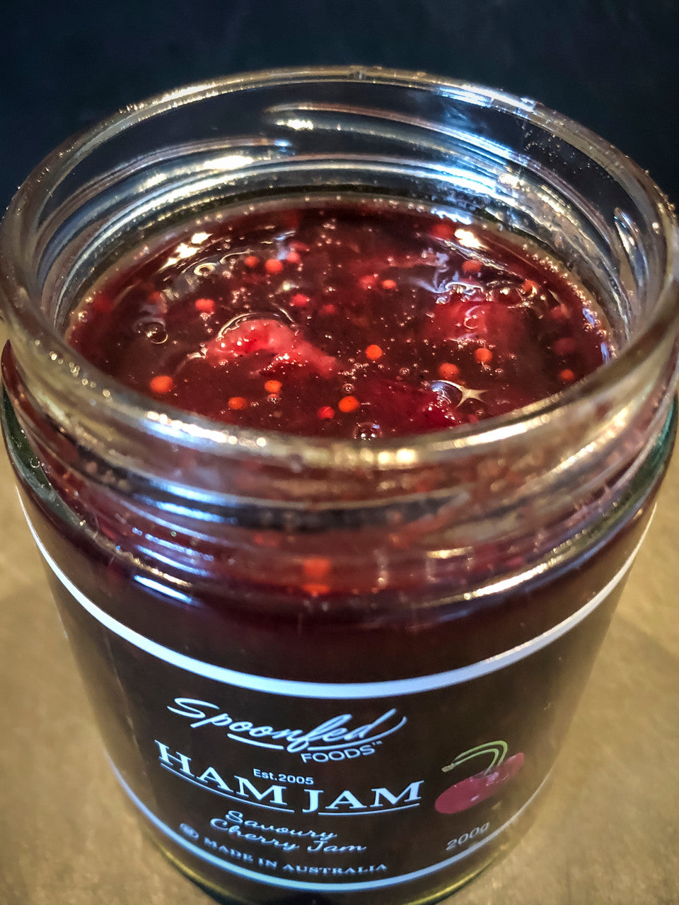 Jar of Ham Jam with visible label on a dark background