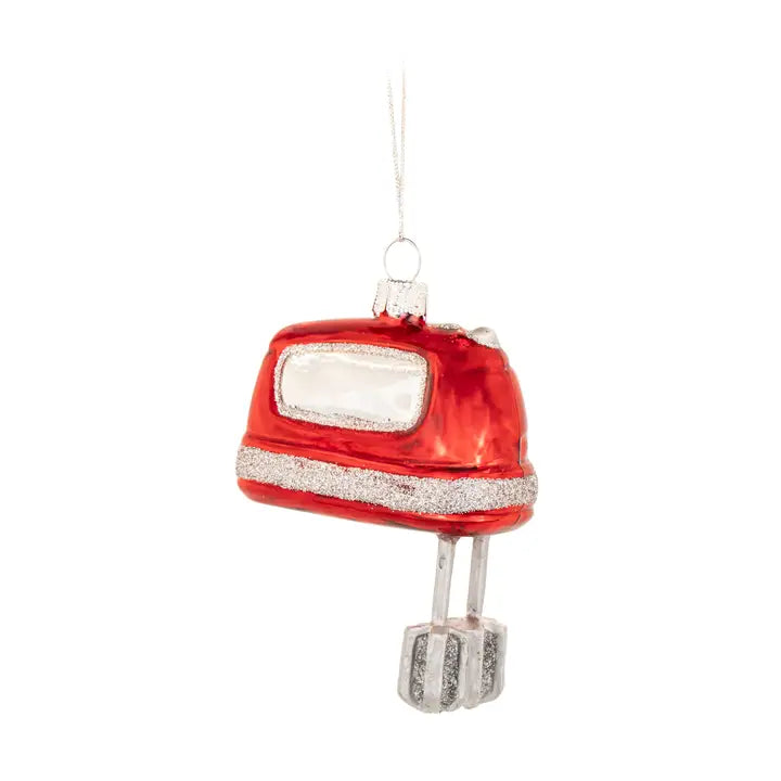 A red retro-style hand mixer ornament with silver glitter accents, a clear window, and a silver hanging loop on a white background.