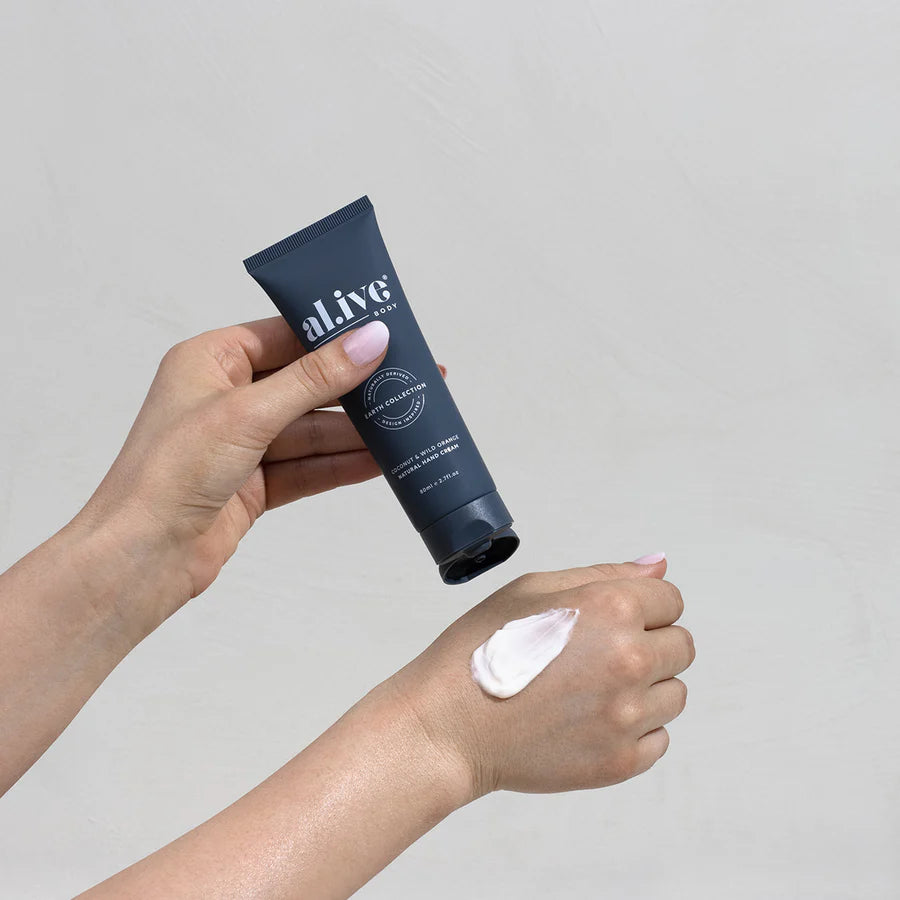 Hand cream tube with lotion on a hand