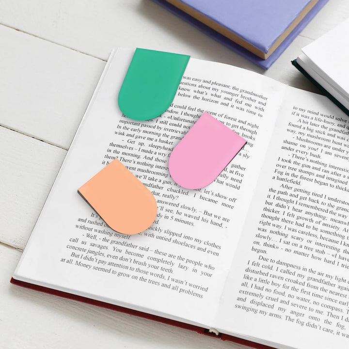 Colorful bookmarks on an open book with a wooden surface background