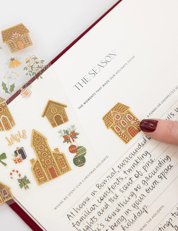 Decorative Christmas stickers on a book with 'The Season' text