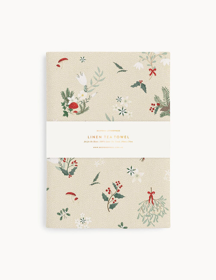 A christmas theme linen tea towel on a white background