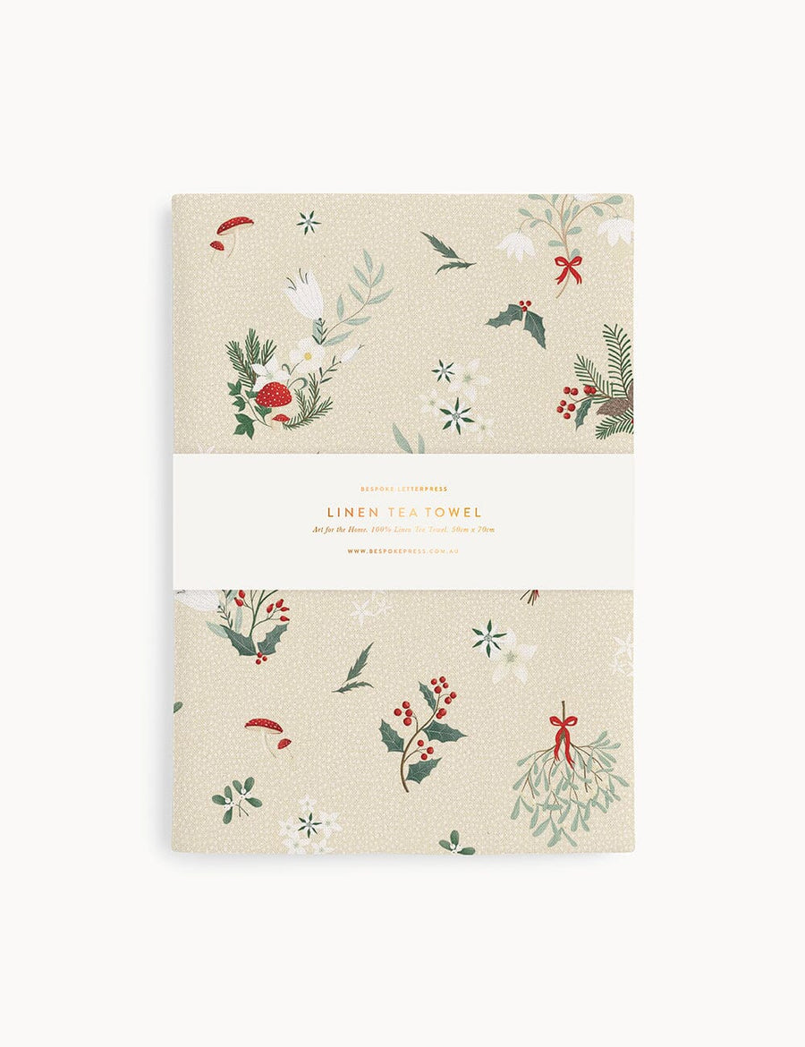 A christmas theme linen tea towel on a white background