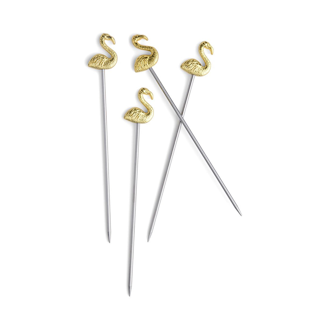 Gold flamingo-shaped cocktail picks on a white background