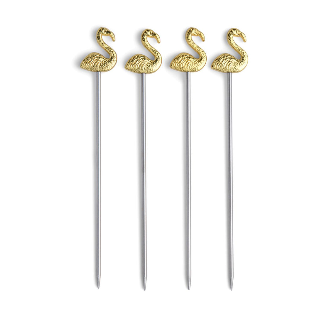 Four gold flamingo-shaped cocktail picks on a white background