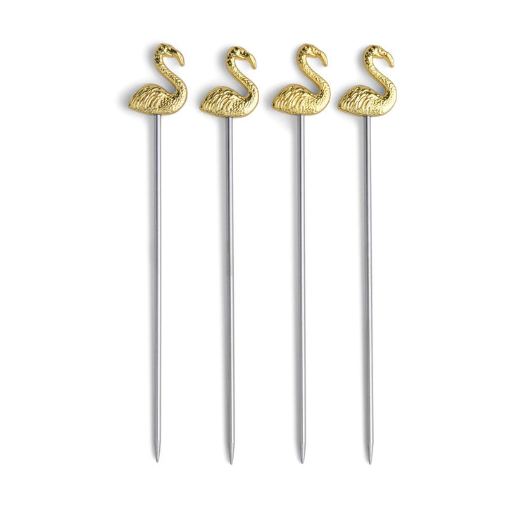 Four gold flamingo-shaped cocktail picks on a white background